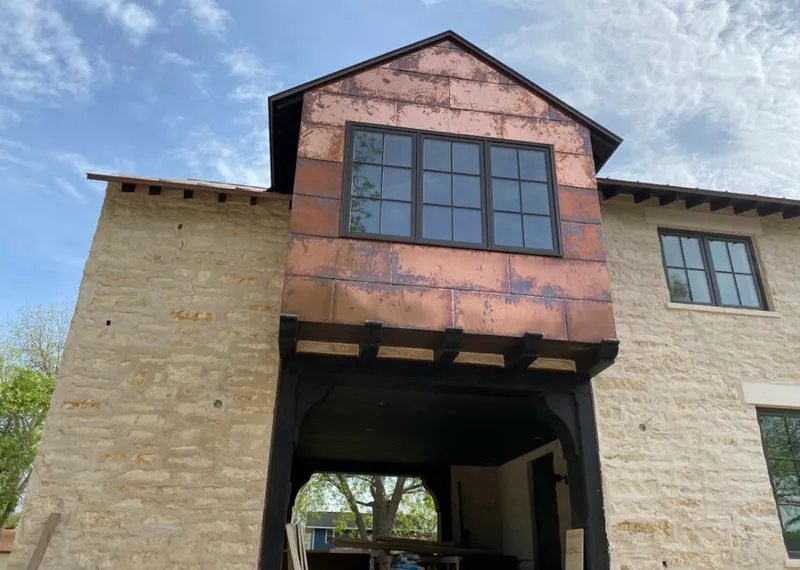 Copper metal panel facade on a stone building for Roof Repair in Orosi