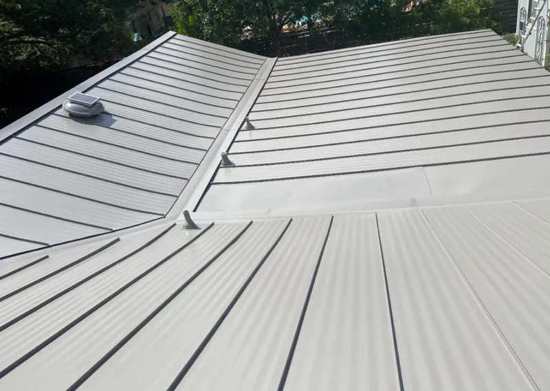 Solar attic fan installed on a metal roof for Roof Ventilation in Orosi
